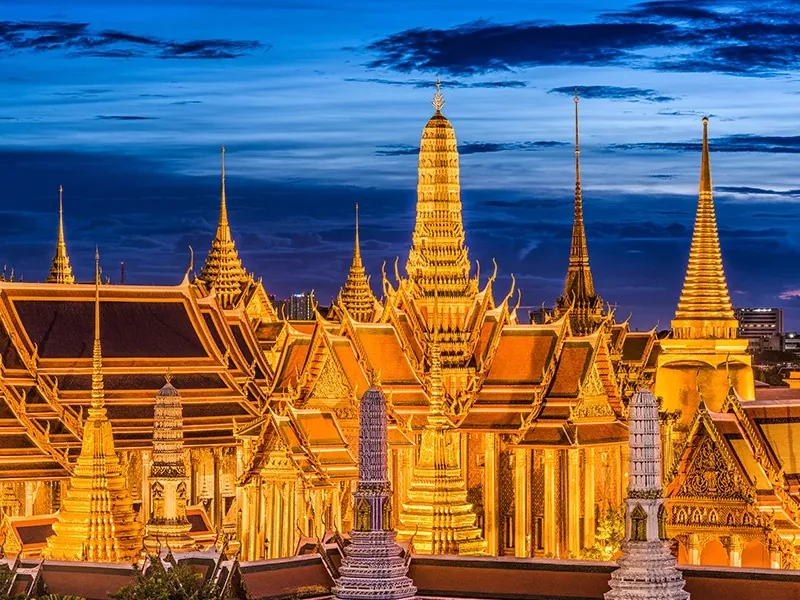 The Grand Palace in Bangkok, Thailand, lit up at dusk